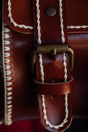 Macro fragment of a leather bag or purse. Handmade, texture background.の写真素材