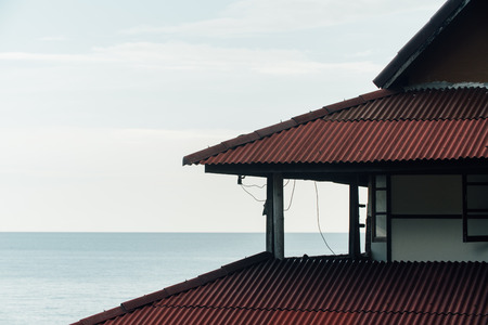 Cascading red roof of the hotel in Asia against the skyの写真素材