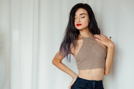 portrait cheerful smiling winking fashion girl with red lips on white background.の写真素材