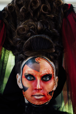 Close-up beauty red art make-up portrait of halloween woman Witch baroque.の写真素材