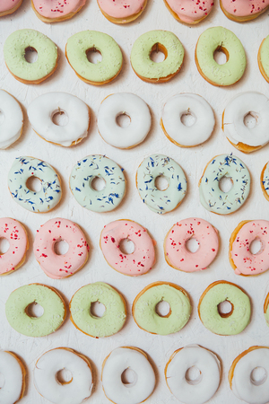 assorted donuts with chocolate frosted, pink glazed and sprinkles donuts.の写真素材