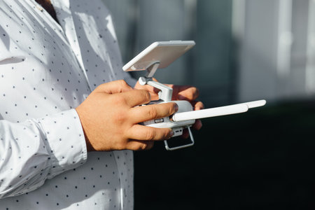 Man holds a drone remote controller in his hands.