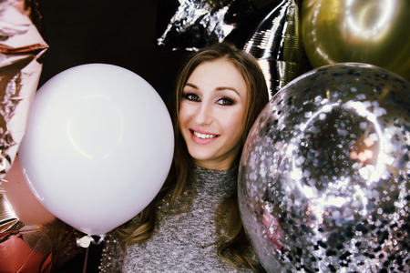 Young beautiful sexy girl with balloons sparkles. At the party, he celebrates his birthday.の写真素材