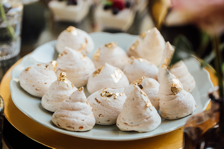 Beze or Meringues on blue plate at the wedding banquet or party.の写真素材