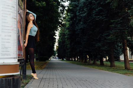 Elegant ballet dancer woman dancing ballet in the cityの写真素材