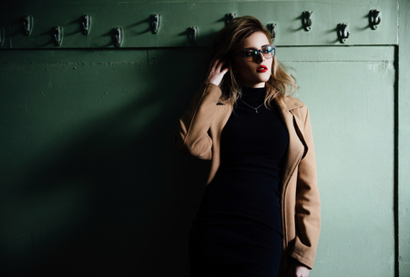 Trendy Hipster Girl in glasses on vintage dressing room background.の写真素材