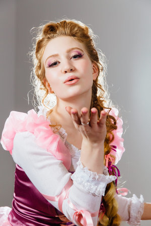 beautiful young girl with curly hairstyle. Magnificent princess in vintage dress