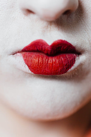 Woman in geisha makeup and a traditional Japanese kimono. Studio, Indoor.の写真素材
