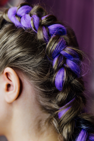 girl in the beauty salon is weaved with braids. braided pigtails.の写真素材