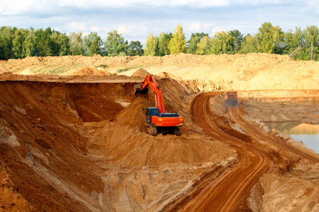Loading sand into trucks on the sandy career, Mining. Excavators and trucks
