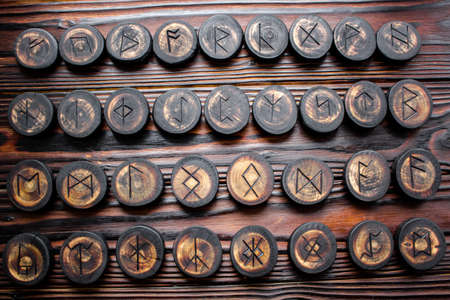 Set of anglo-saxon runes carved in wood - anglo-saxon futhark (futhorc)の写真素材