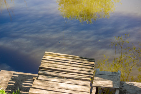 Small pier on the river, a bridge for swimming in the pondの写真素材