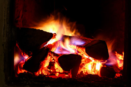 Burning colorful flame logs inside the oven