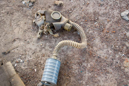 Discharged old gas mask with a filter in the abandoned factoryの写真素材