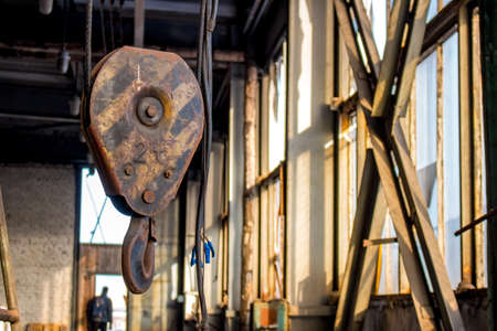 Metal lifting hook on the territory of an industrial buildingの写真素材