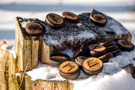 Runes carved from wood on the snow - Elder Futharkの写真素材