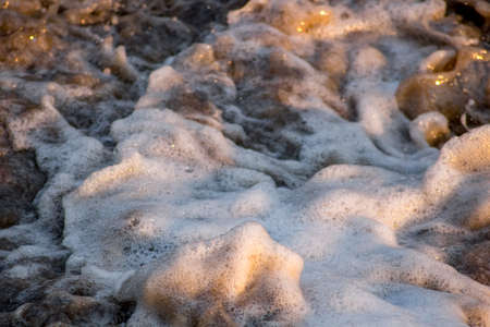 Water splashes with foam, closeup viewの写真素材
