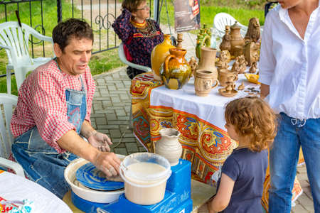 OBNINSK, RUSSIA - JULY 28, 2017: Festival of Folk Art and Crafts. Fair of Crafts. Sculpting on a potter's wheelのeditorial素材