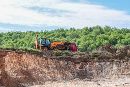 Novomikhailovskoe, Russia - May 2016: Limestone quarry, machinery removes a fertile layer of landのeditorial素材