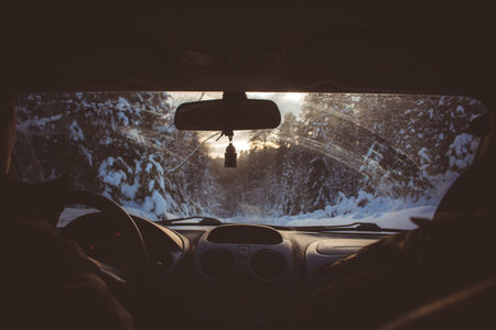 A trip in the car on a snowy road, inside view