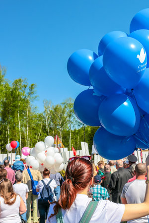 Obninsk, Russia - May 9, 2016: Celebration of the Victory Day, Great Patriotic War 1941-1945. A girl with a bunch of blue balloonsのeditorial素材