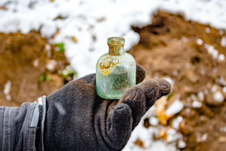 Search for antique glass bottles and artifacts in the groundの写真素材
