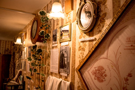 Borovsk, Russia - May 2016: Museum of the History of the Merchants of Borovsk in the House of the Polezhayevykh. Wall of the room with photos, a clock and a lampのeditorial素材