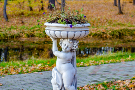 Sculpture-vase in antique style in the park in autumnの写真素材