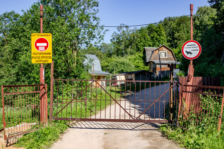 Kaluzhskiy region, Russia - June 2018: Overlapped entry to the territory of summer cottagesのeditorial素材