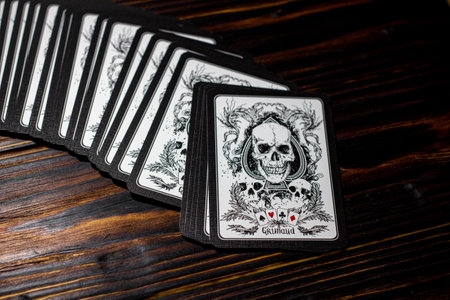Russia - February 2019: Playing cards "Grimaud" with skulls on the vintage tableのeditorial素材