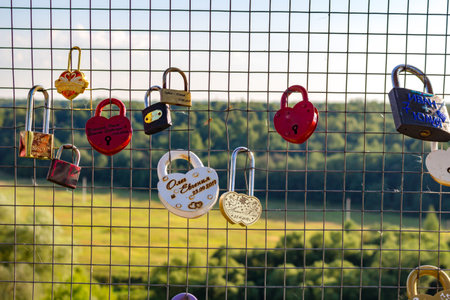 Ermolino, Russia - August 2018: A bunch of wedding locks on the fence of the observation platform in Rusinovo. Kaluzhskiy region, Borovskiy district, Ermolinoのeditorial素材