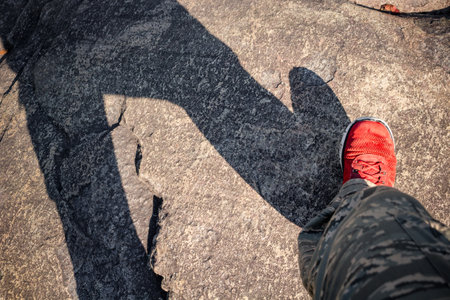 Walk on a stony surface, foot on the surface of the stoneの写真素材
