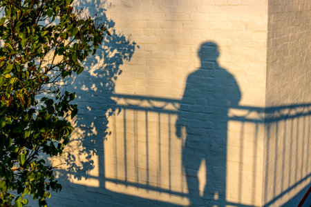 The shadow of a man on a white building wallの写真素材
