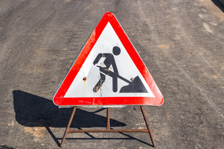 Road repair sign on the road in city