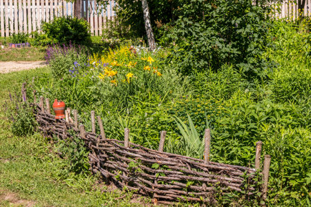 Wicker fence of dry branches on the summer cottageの写真素材