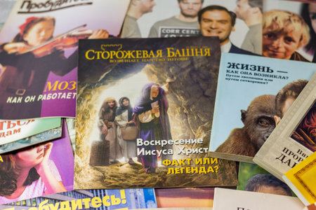 Russia - December 2020: Religious literature of Jehovah's Witnesses (organization banned in Russia). The Watchtower magazine of the early 2000s in Russian and booksのeditorial素材