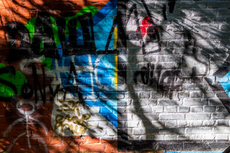 Fragment of brick wall painted with paint, abstract backgroundの写真素材