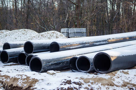 Plastic sewer pipes prepared for installation. Reconstruction of the city sewage system