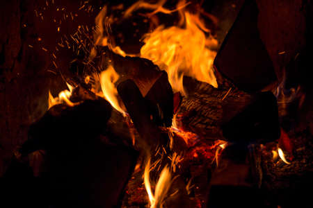Burning logs in the oven. Flame in the fireplace. Cozy home hearth