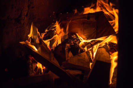 Burning logs in the oven. Flame in the fireplace. Cozy home hearthの写真素材
