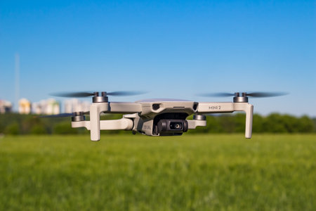 DJI Mini 2 drone in flight with fields and houses in the background: Russia - June 2021のeditorial素材