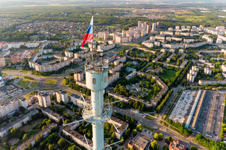 Aerial view of a meteorological mast with a flag of Russia and a panorama of urban development in the city of Obninsk, Russia. June 2021の写真素材