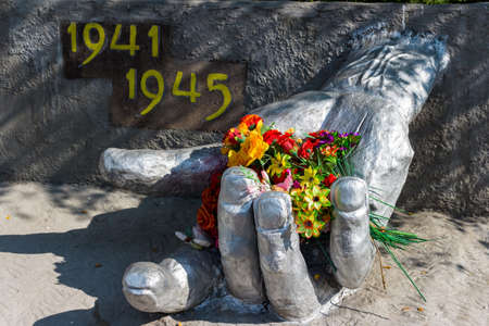 War memorial, hand with flowers. Monument of the Great Patriotic War 1941-1945 in the military town...