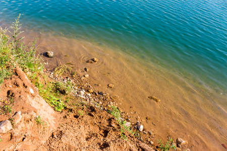 Beautiful sandy beach with rocks and clear turquoise waterの写真素材