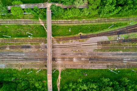 Pedestrian bridge over railway tracks, right angle aerial viewの写真素材