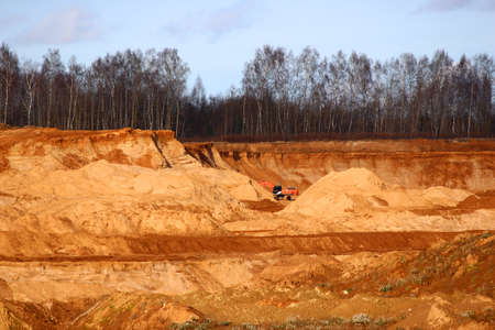 Sand pit with excavator in the backgroundの写真素材