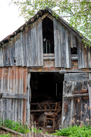 Old wooden rustic barn with various junk inside, vertical viewの写真素材