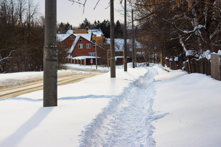 Path trampled by pedestrians in the snow, snow-covered streets in winterの写真素材