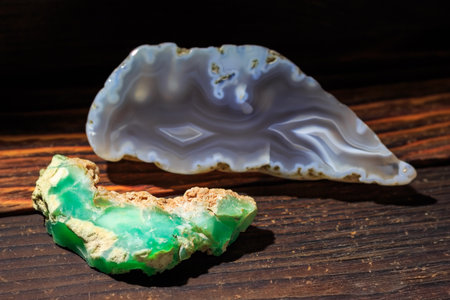 Raw green chrysoprase against a background of polished blue agate, a variety of chalcedony