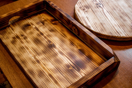 Homemade tray on the table, wood after firing and impregnation with linseed oil